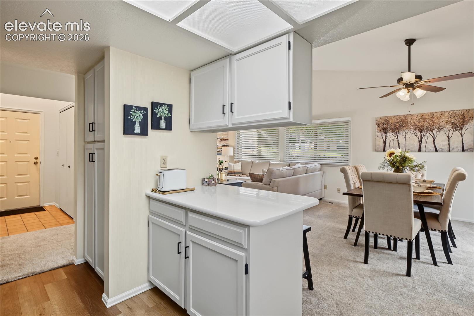 Kitchen featuring white cabinetry and a white countertop