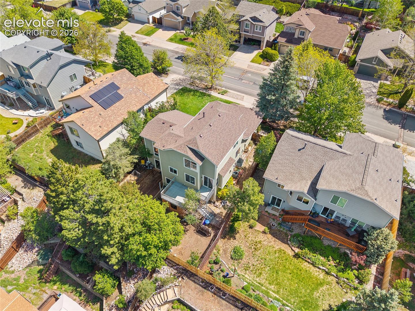 Residential property featuring a multi-level design with a shingle roof