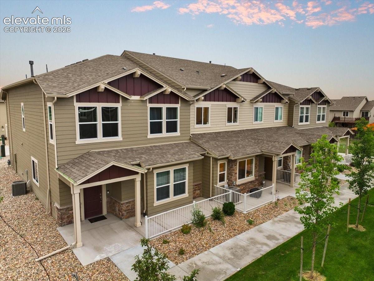 Multi-unit property featuring siding and stone exterior accents