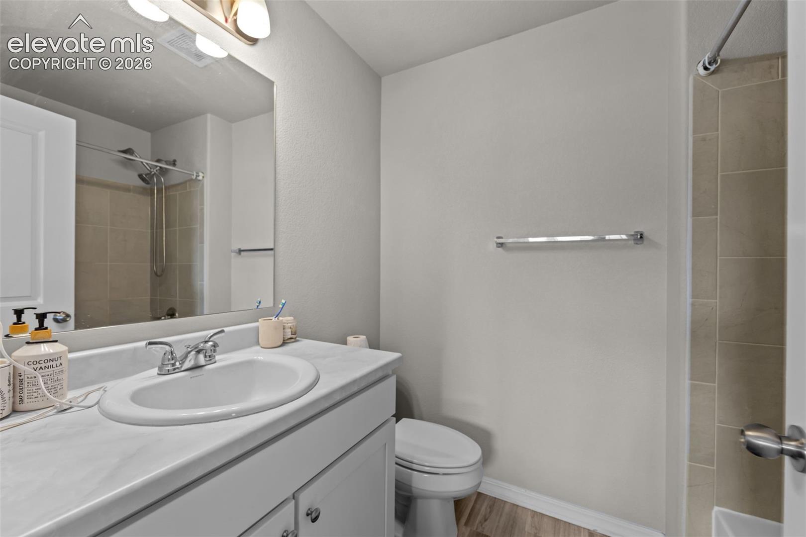 Vanity with integrated sink, chrome faucet, and white cabinetry