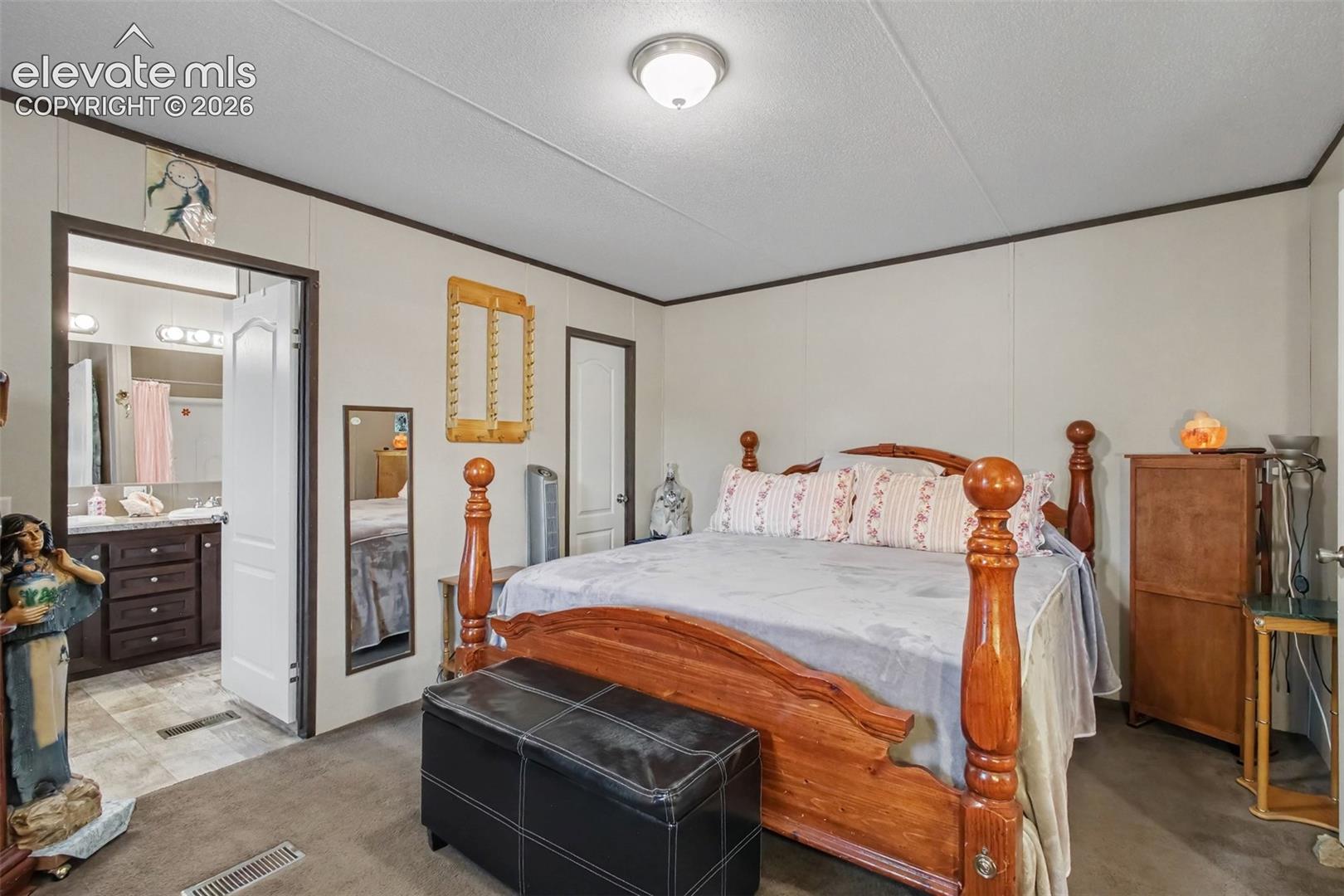 2nd Home: Comfortable and inviting primary bedroom with direct access to the adjoining bathroom and walk in closet, creating a private and convenient retreat.