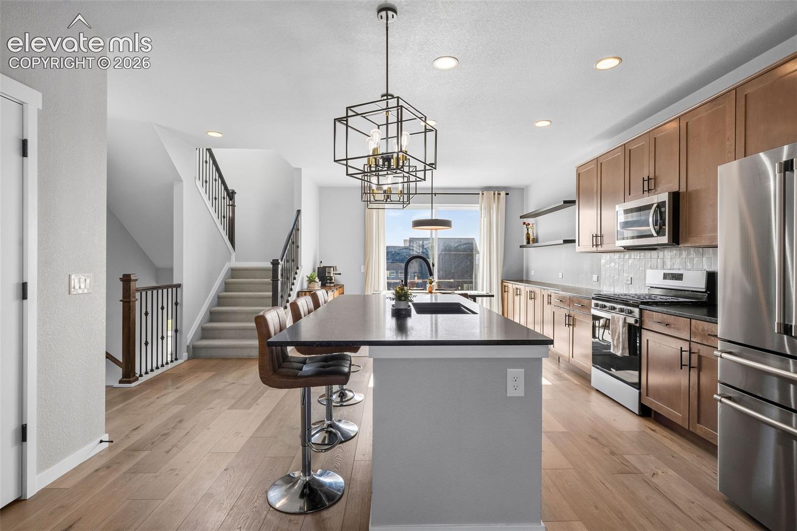 View of the kitchen from the living room. Grab a snack without missing a beat. 