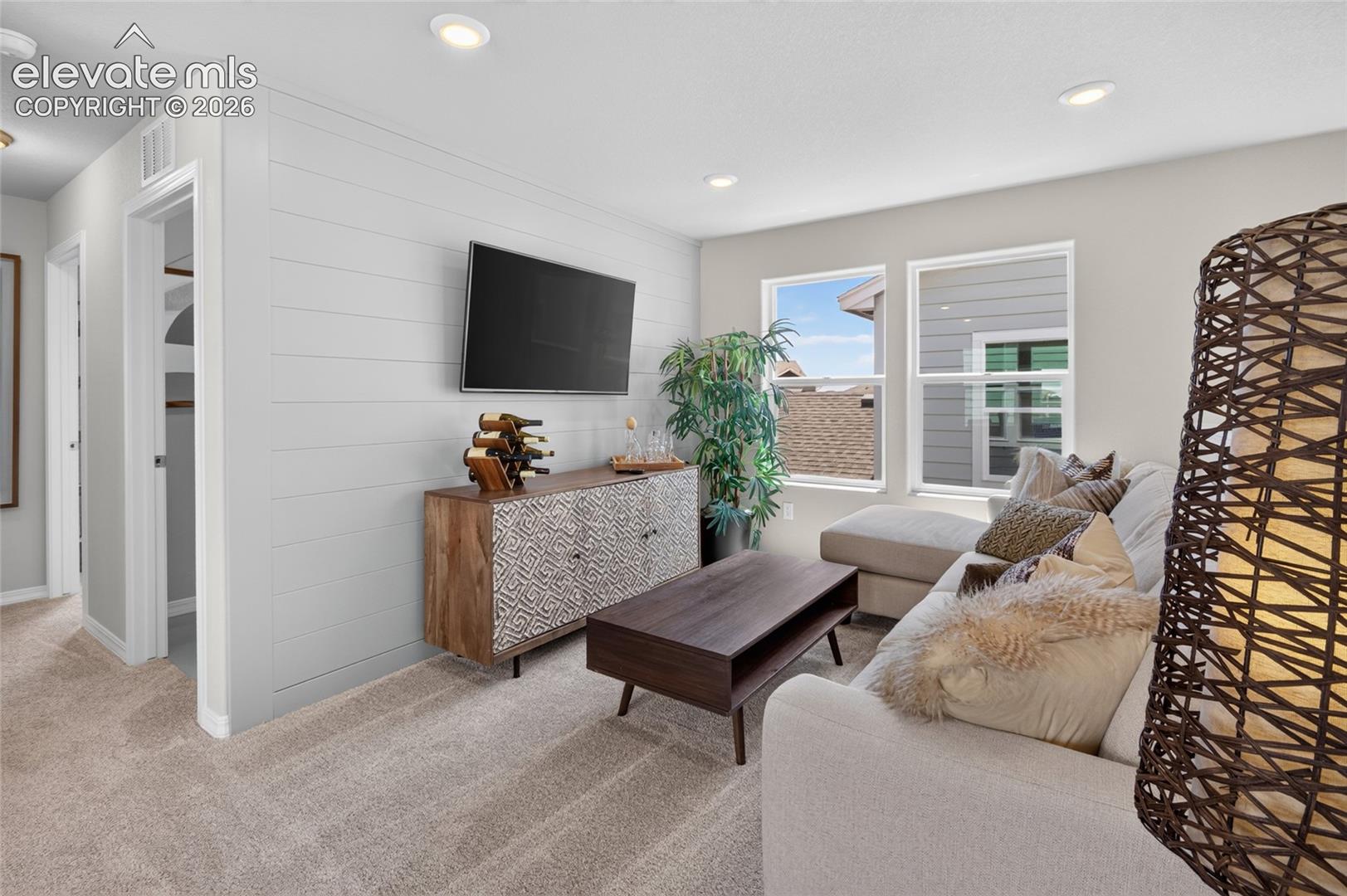 Accent wall featuring horizontal shiplap paneling, neutral wall-to-wall carpeting, and recessed ceiling lighting