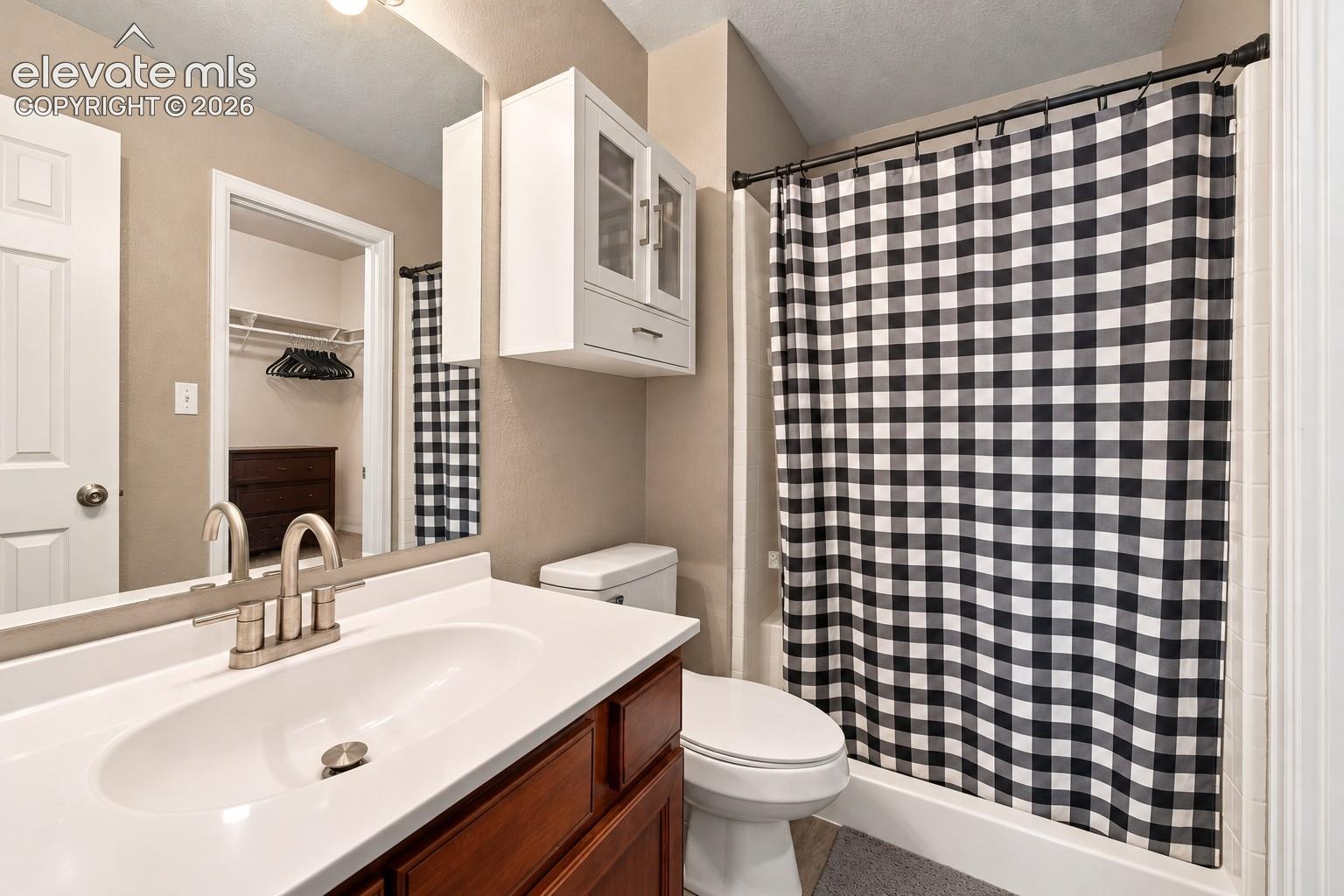 Bathroom with a single vanity, undermount sink, and brushed nickel faucet