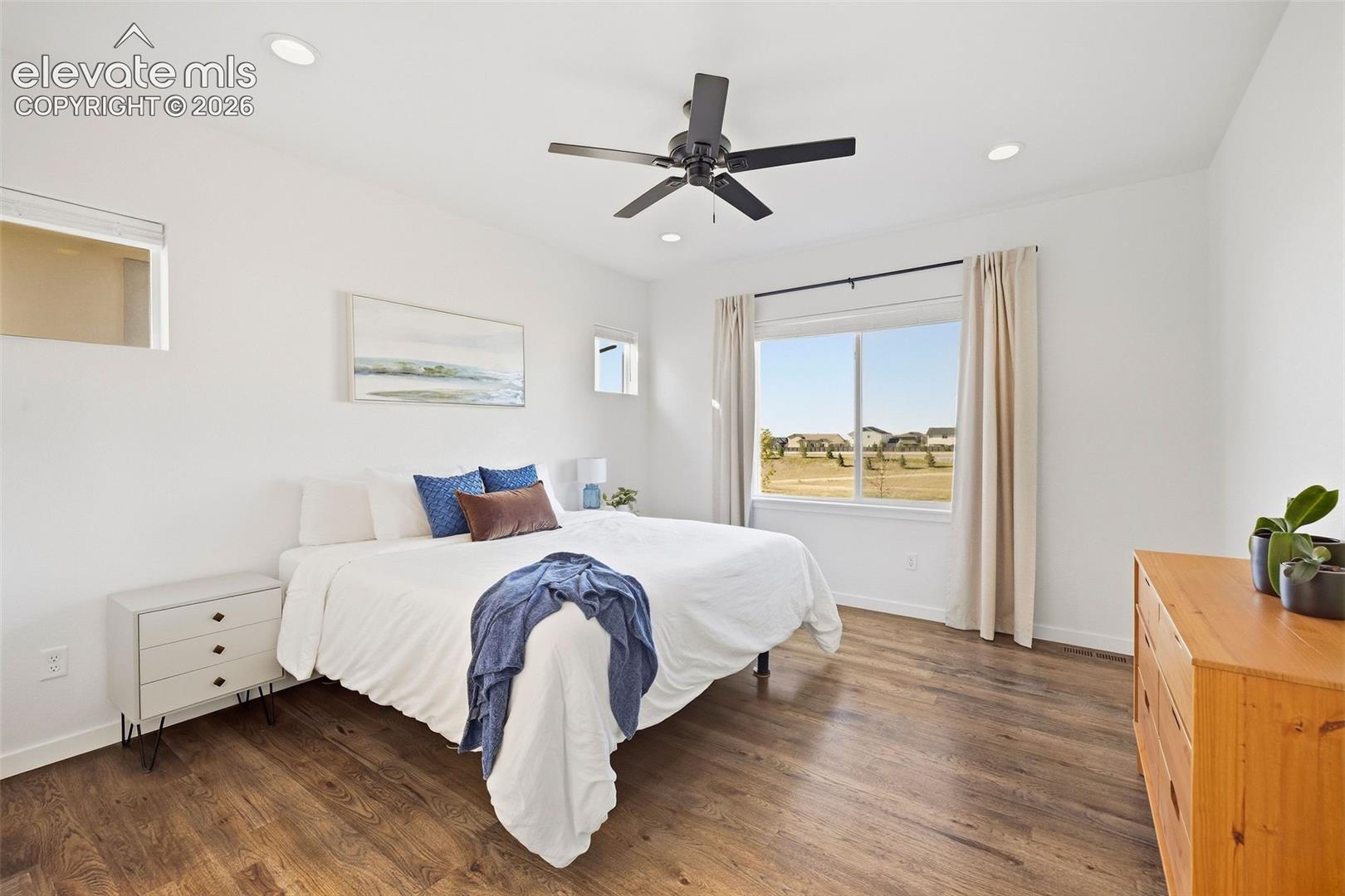 Wake up to why you live here! The main-level primary bedroom has incredible mountain views that you can enjoy with complete privacy as there are no homes behind you. There are upper transom windows, a ceiling fan and an ensuite bath. And of course those gorgeous REAL hardwood floors!