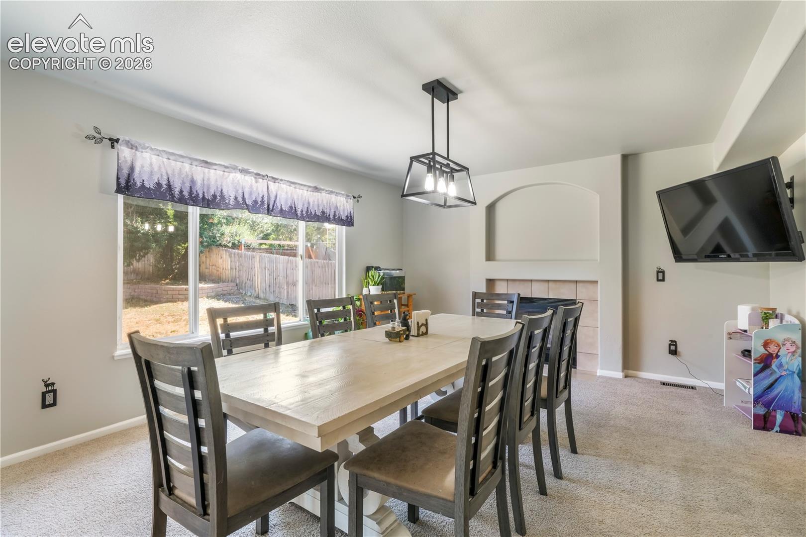 Currently staged as dining area, also family room with gas fireplace