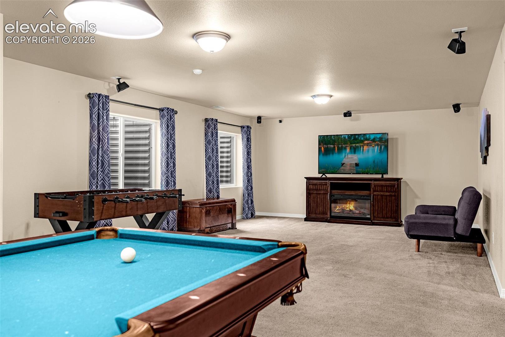 Open interior space with wall-to-wall carpeting, recessed ceiling lighting, surround sound speaker mounts, and dual window wells