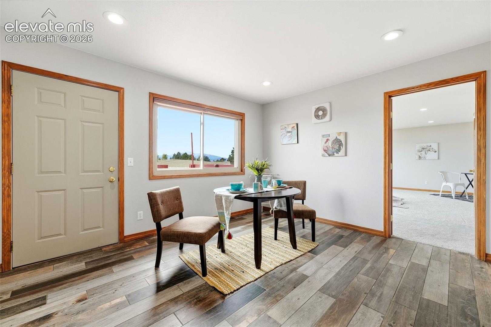 Wood-finish flooring with natural wood trim and door frames