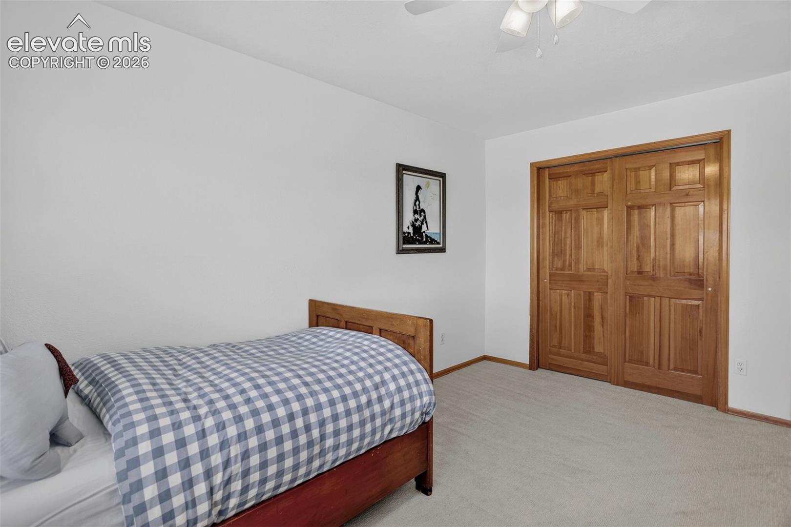 Bedroom featuring light-colored carpeting and white walls
