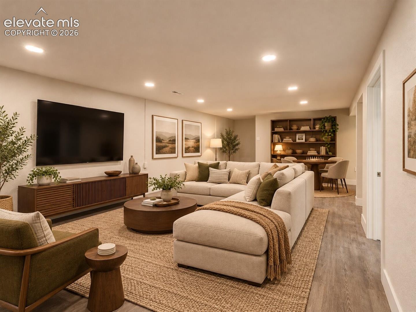 Recessed lighting, wood-finish flooring, and built-in shelving. AI-Enhanced – furniture/decor digitally added