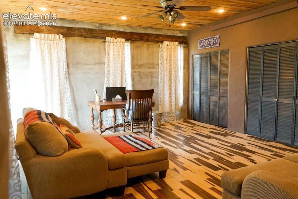 Wood-plank ceiling with recessed lighting and a ceiling fan
