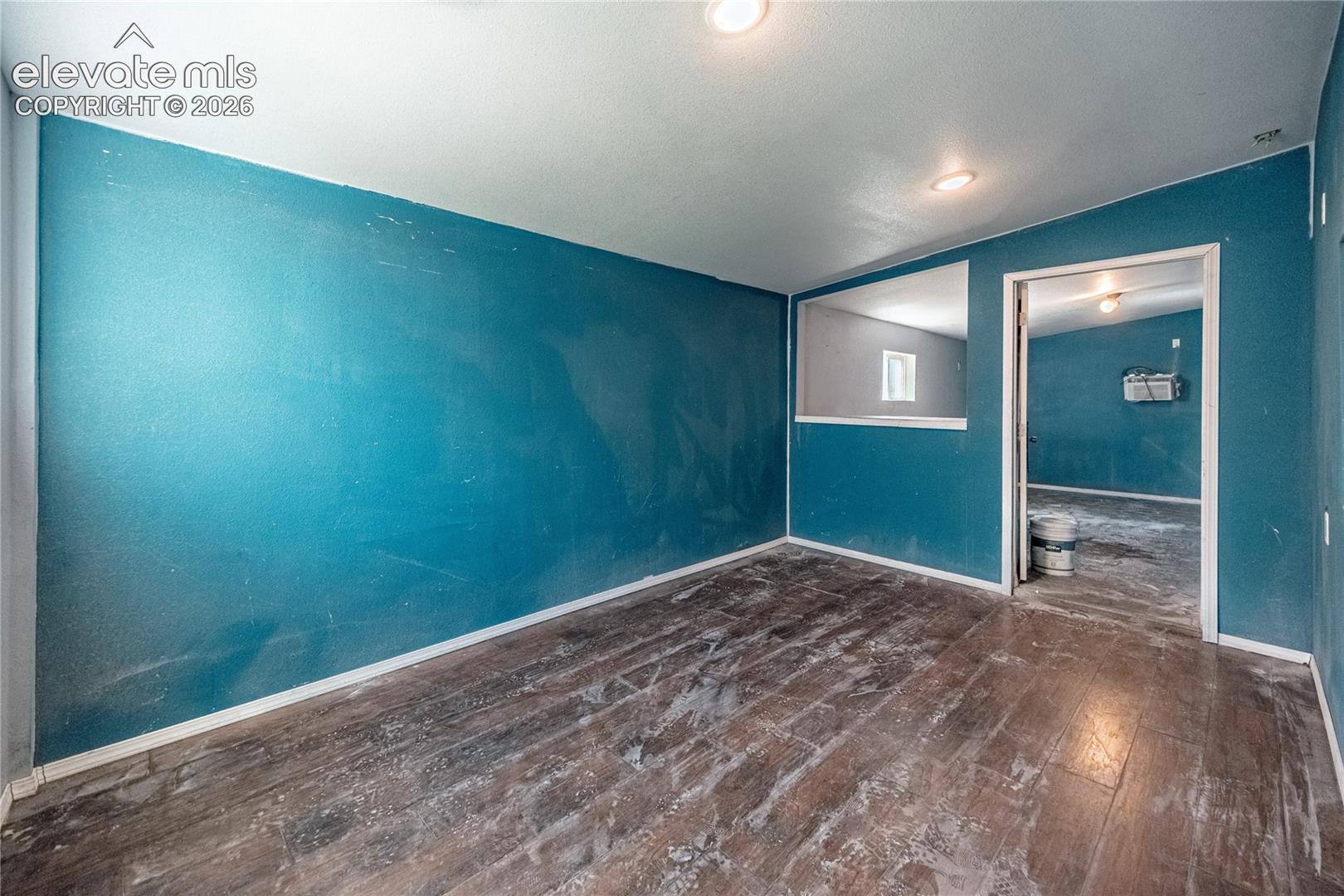 Wood-finish flooring with a teal wall finish