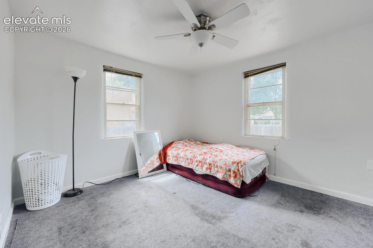 Recessed lighting, two windows with blinds, and a ceiling fan with light