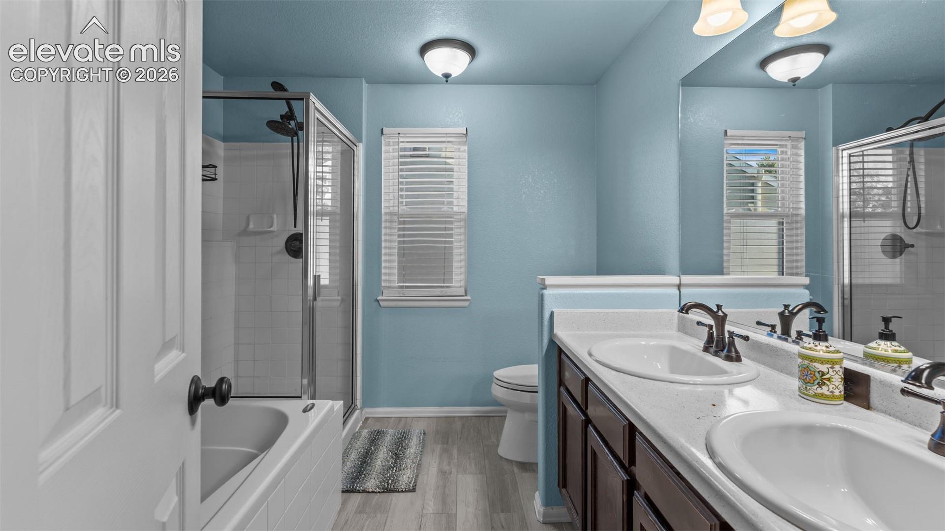 Dual vanity with undermount sinks, bronze finish fixtures, and a large mirror