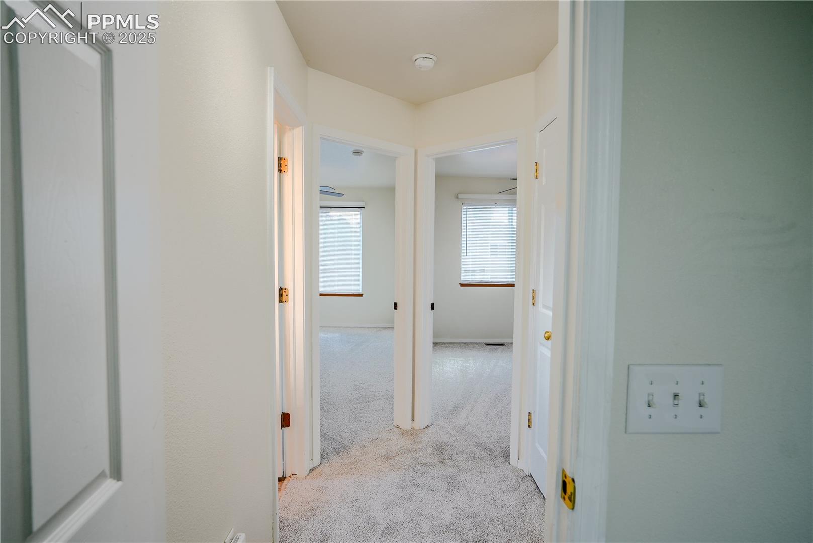 Hallway featuring carpet flooring