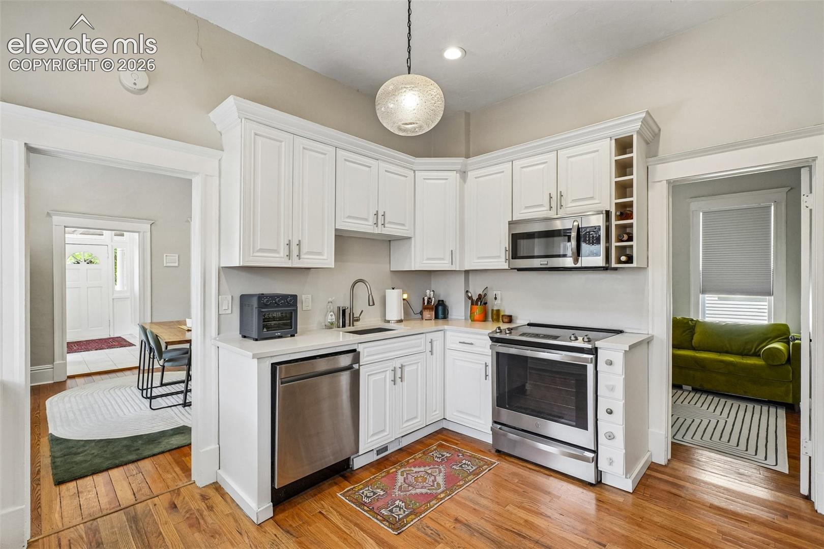 Kitchen with matching stainless steel appliances, wood flooring and plenty of cabinet space