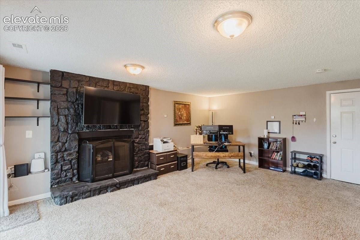 Family room with fireplace and door to garage
