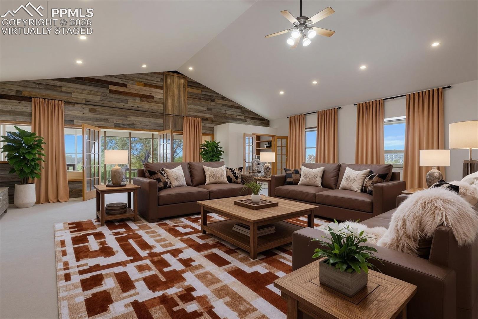 virtually staged Spacious living area featuring a vaulted ceiling, recessed lighting, and a wood-paneled accent wall