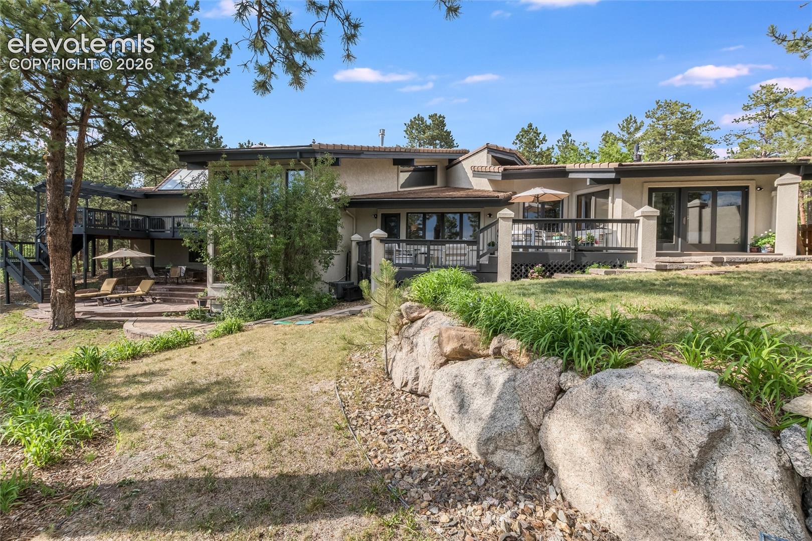 Rear elevation featuring multiple outdoor entertaining areas