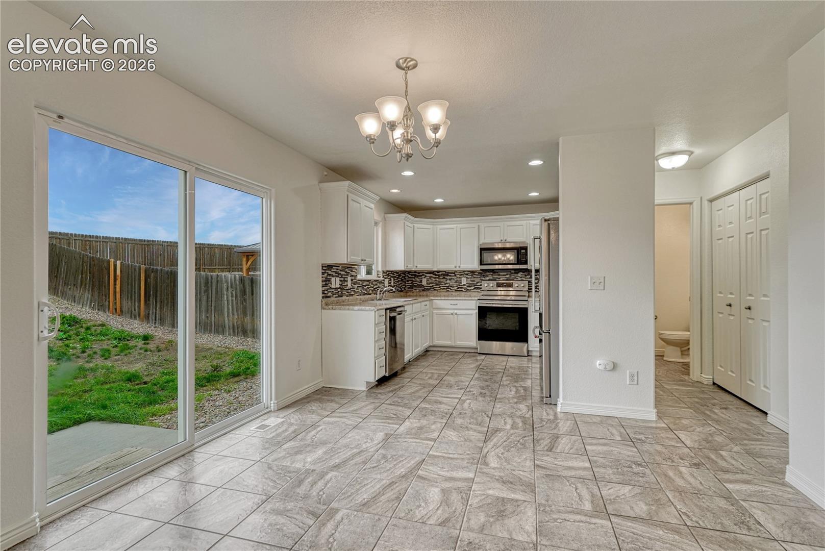 Dining area with walk-out to the fenced backyard. 
