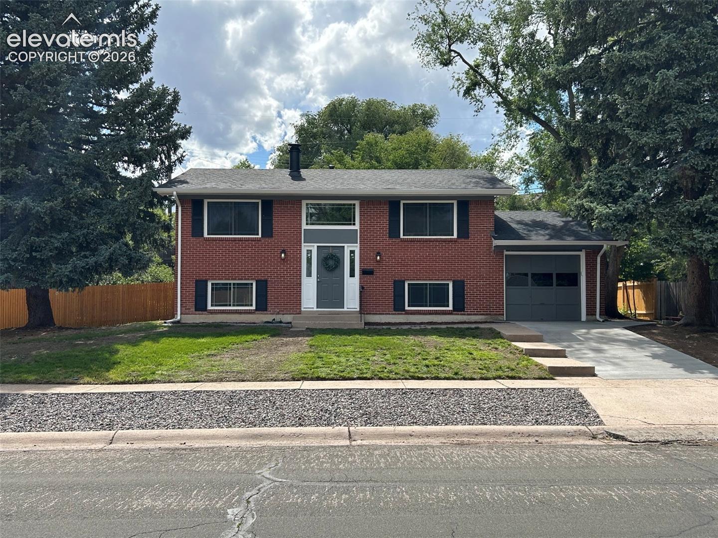 Welcome home to a top-to-bottom transformation that's truly move-in ready! This stunning property has been completely renovated, leaving nothing untouched—brand new roof, electrical panel, plumbing, interior and exterior paint, deck, fence, concrete driveway, and patio. Every door, floor, light fixture, and finish has been updated, so you can skip the project list and just move right in.Step inside to an open-concept main level featuring a gorgeous new kitchen with custom cabinets, stone countertops, a stylish island, and brand new appliances—all flowing seamlessly into the dining area and family room. The dining space walks out to a brand new deck overlooking a huge, fully fenced backyard, perfect for entertaining, gardening, or simply relaxing outdoors.Two spacious bedrooms and a fully remodeled full bath complete the main level. Downstairs, the finished basement offers an expansive rec room with a cozy wood-burning fireplace and walk-out access to a covered patio and backyard—plus two additional bedrooms and a beautifully remodeled 3/4 bath, ideal for guests, family, a home office, or hobbies.Additional highlights include a newer furnace and water heater, central air conditioning, an oversized attached garage, extra RV parking, and a generous 0.20-acre lot offering privacy and room to roam. Located near schools, parks, shopping, and a hiking trail, this home combines comfort, convenience, and quality in one incredible package.This is a rare opportunity to own a fully renovated home where everything has already been done for you. Incredible value, stunning updates, and a fantastic lot make this one a must-see—schedule your showing today before it's gone!