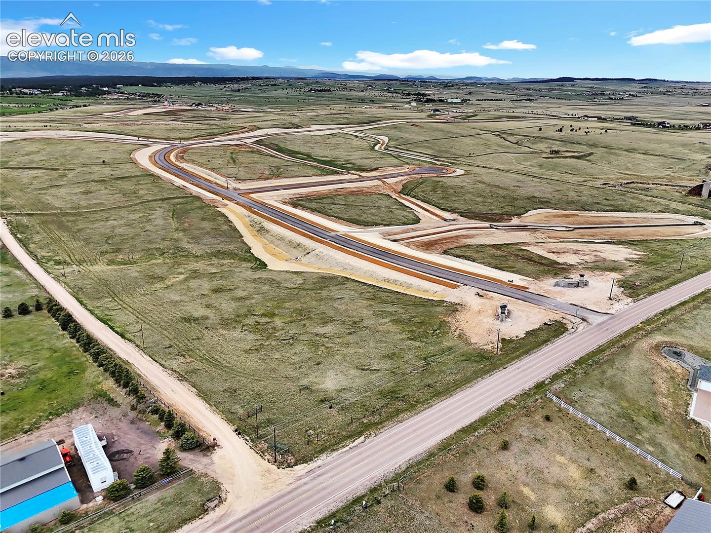 Expansive lot featuring paved road access, utility infrastructure, rolling topography, and unobstructed mountain terrain backdrop