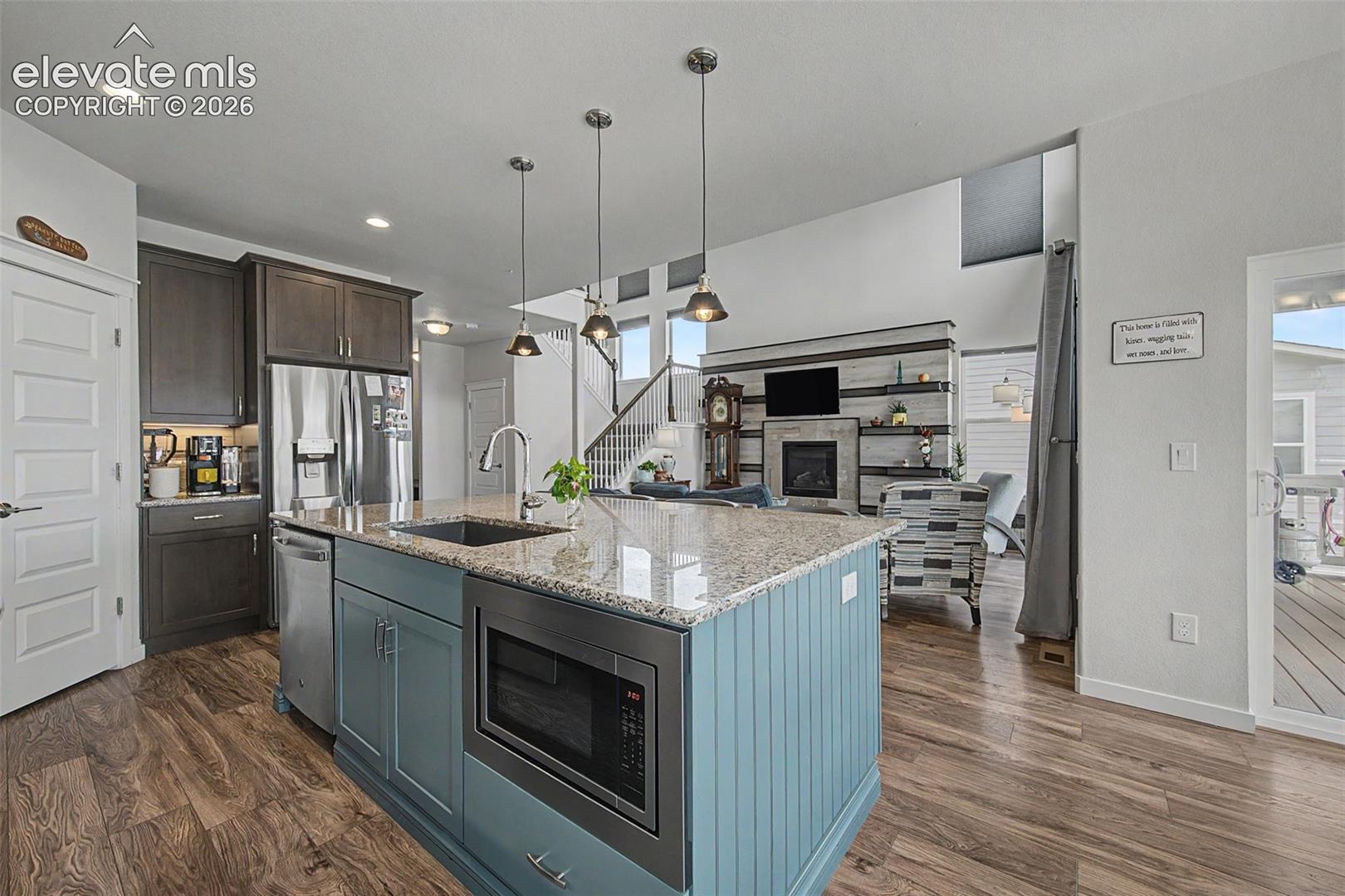 The island features a farmhouse sink, built-in microwave and dishwasher.