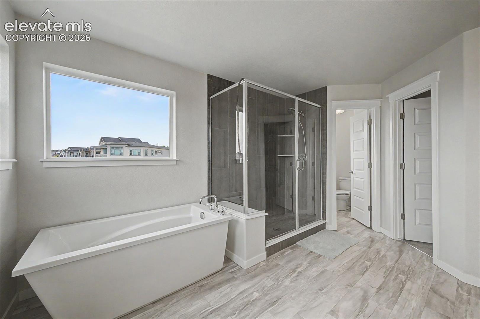 The primary bath includes a water closet and access to a walk-in closet.