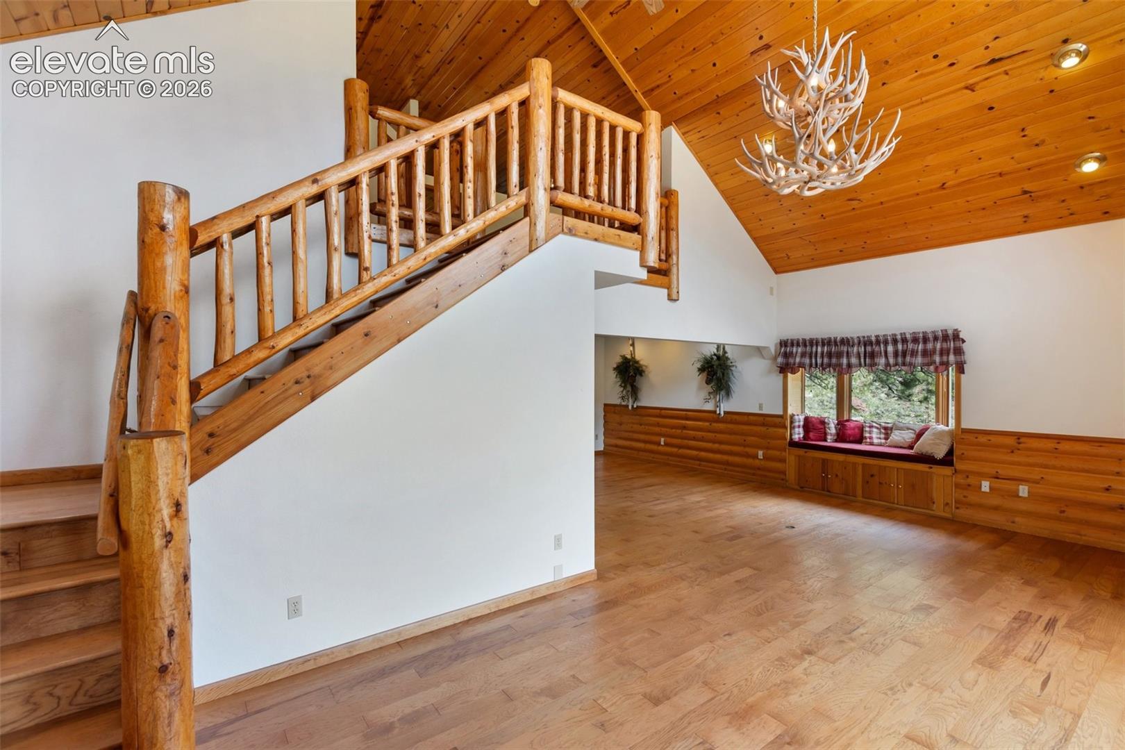 Family room with log stair case. 