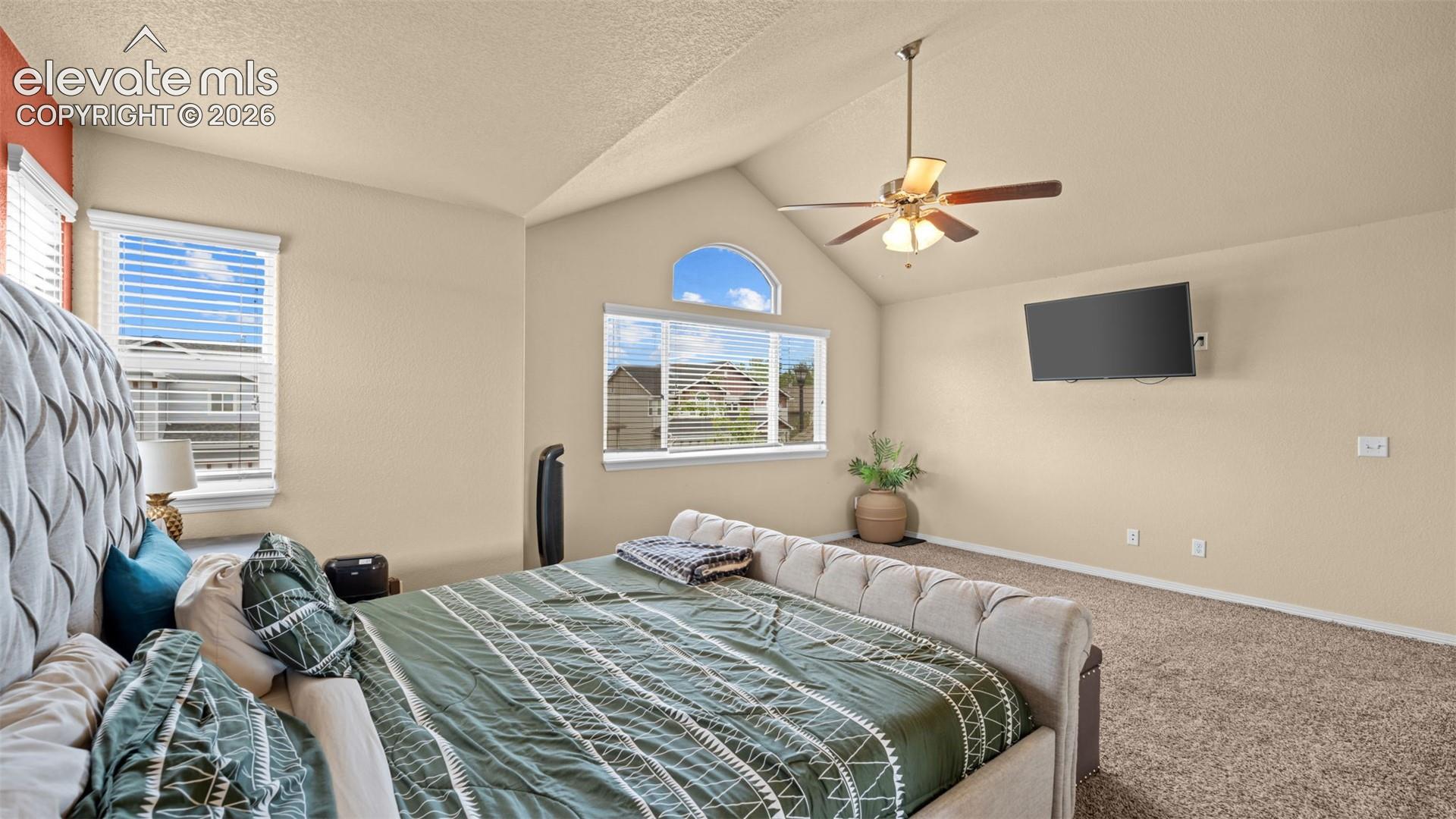 Vaulted ceiling with a ceiling fan and light fixture