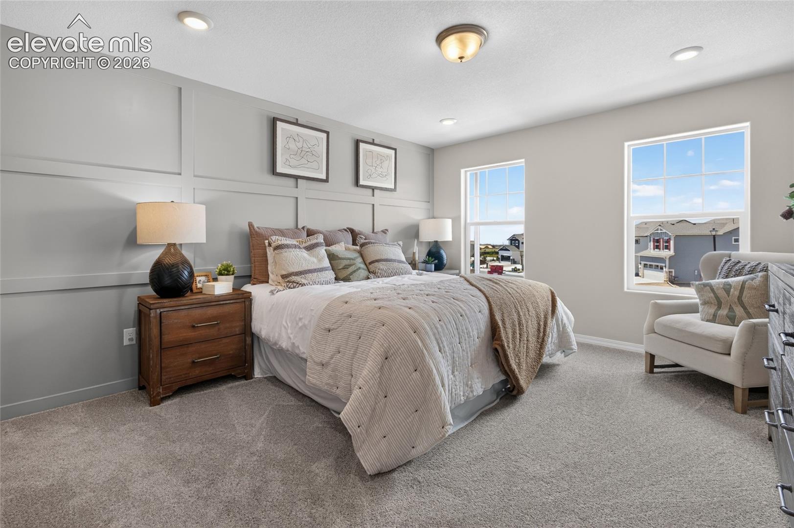 Room featuring wainscoting accent wall, wall-to-wall carpeting, recessed lighting, and dual windows