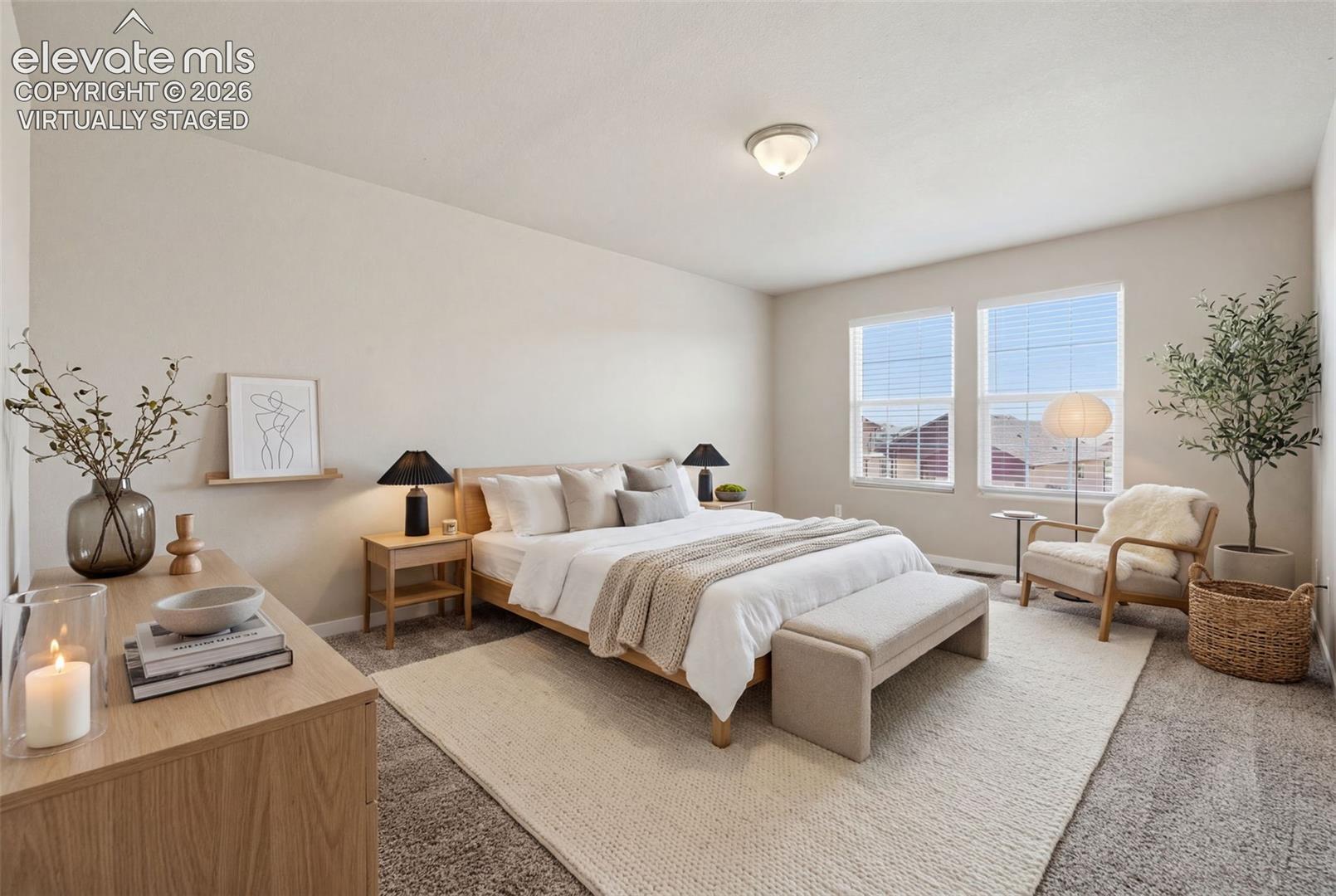 Virtually staged to demonstrate the generous scale of the primary suite, with room for a king-size bed and additional furniture.