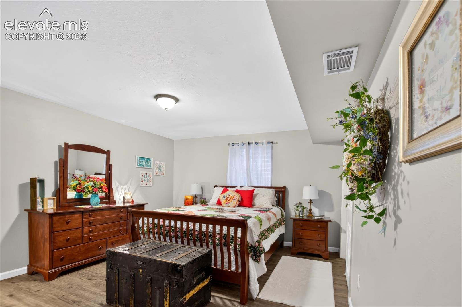 Recessed ceiling, wood-finish flooring, light-toned walls, and a window with white blinds