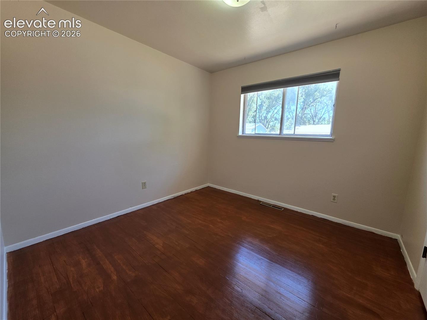Hardwood-finish flooring with light-toned walls and white trim