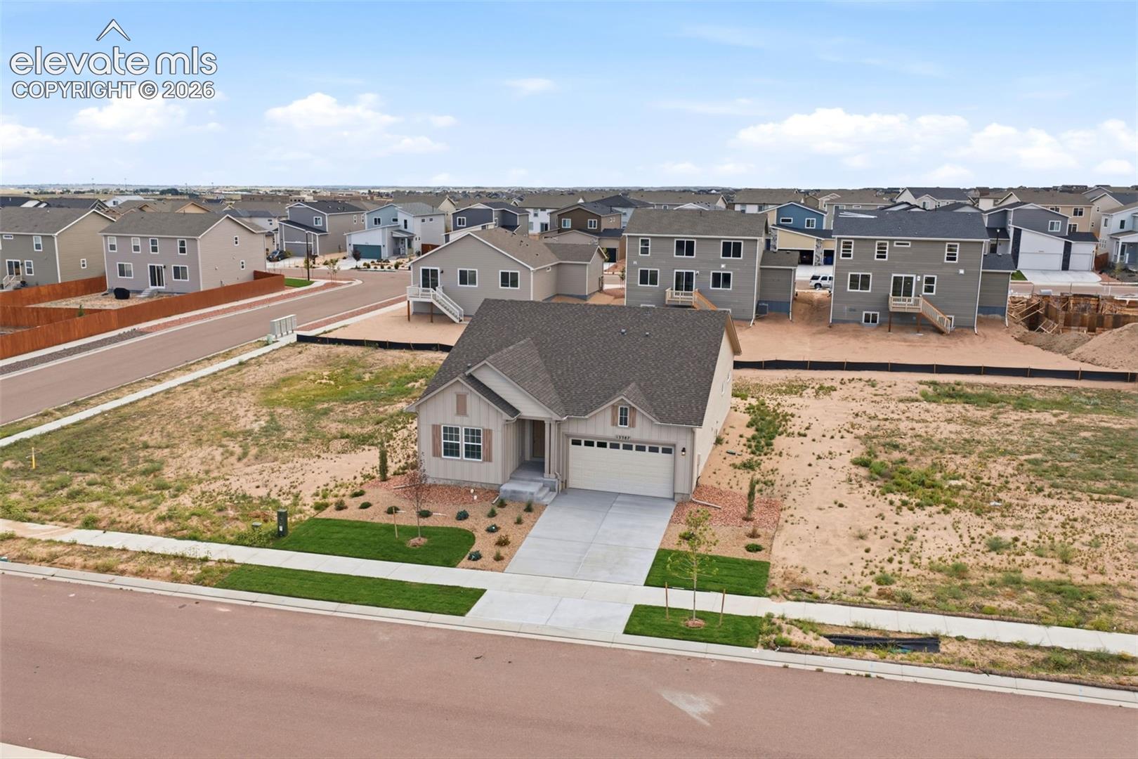 Single-story residence with a concrete driveway, two-car garage, and neutral exterior siding