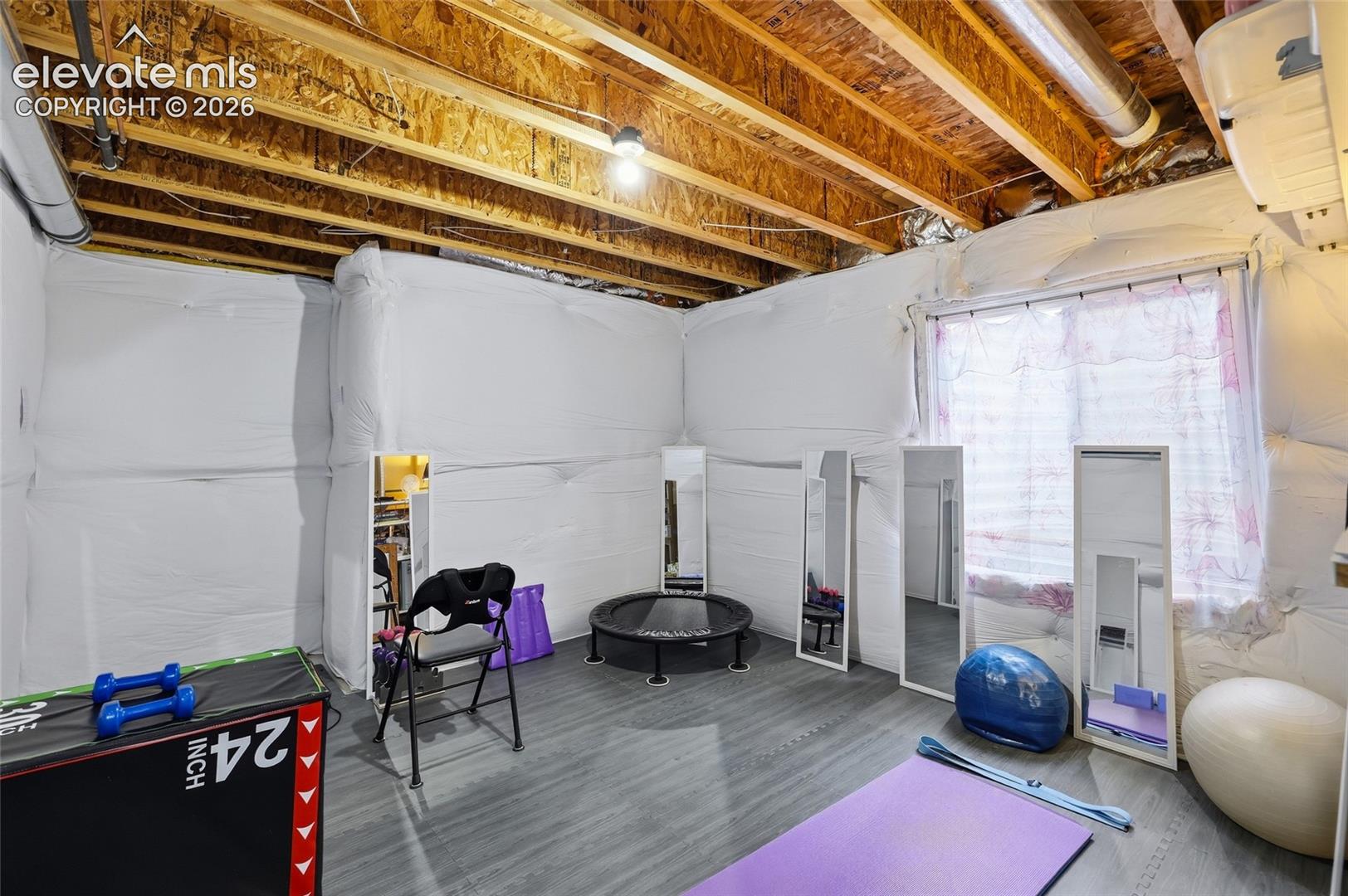 Basement: Unfinished basement space featuring exposed wood joists and structural elements