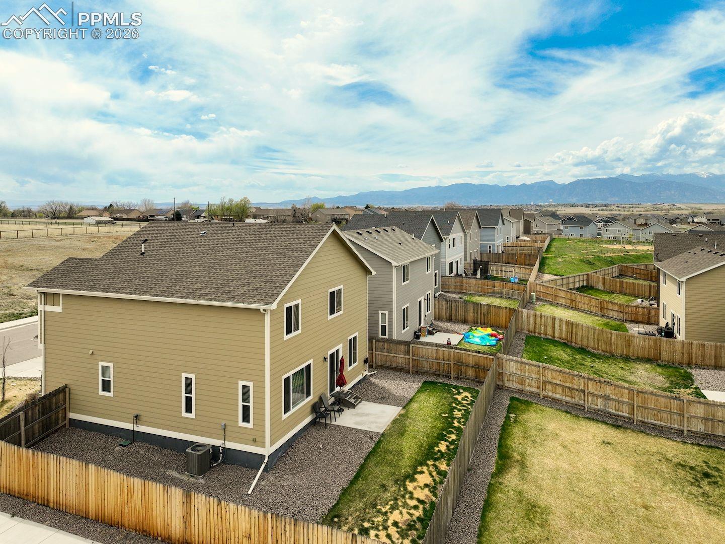 Aerial view of residential area featuring a mountainous background