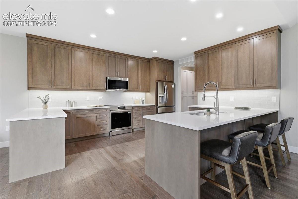 Gourmet Kitchen with Quartz Countertops, Stainless Steel Appliances, and Induction Range.