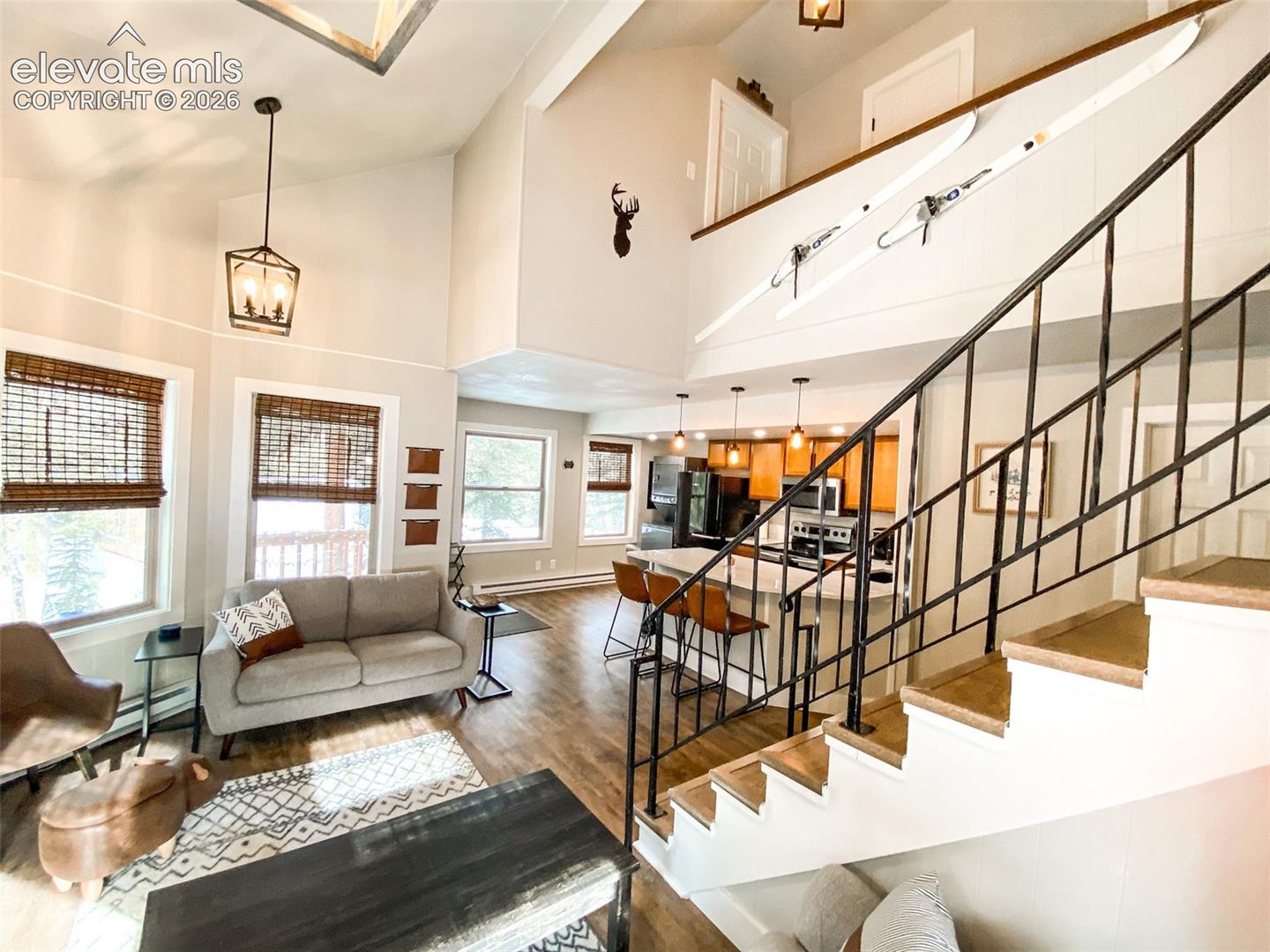 Two-story living area featuring a vaulted ceiling and an open-concept design