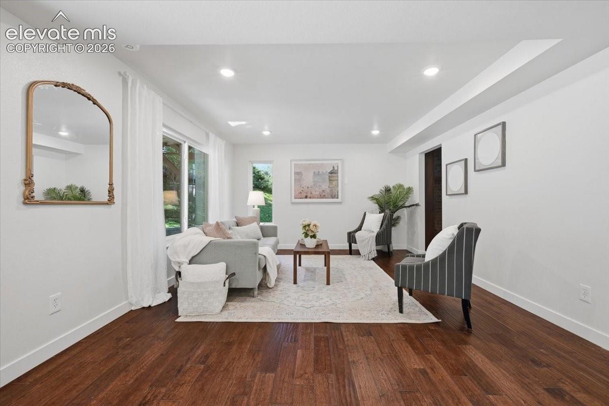 Recessed ceiling lighting, wood flooring, and a sliding glass door
