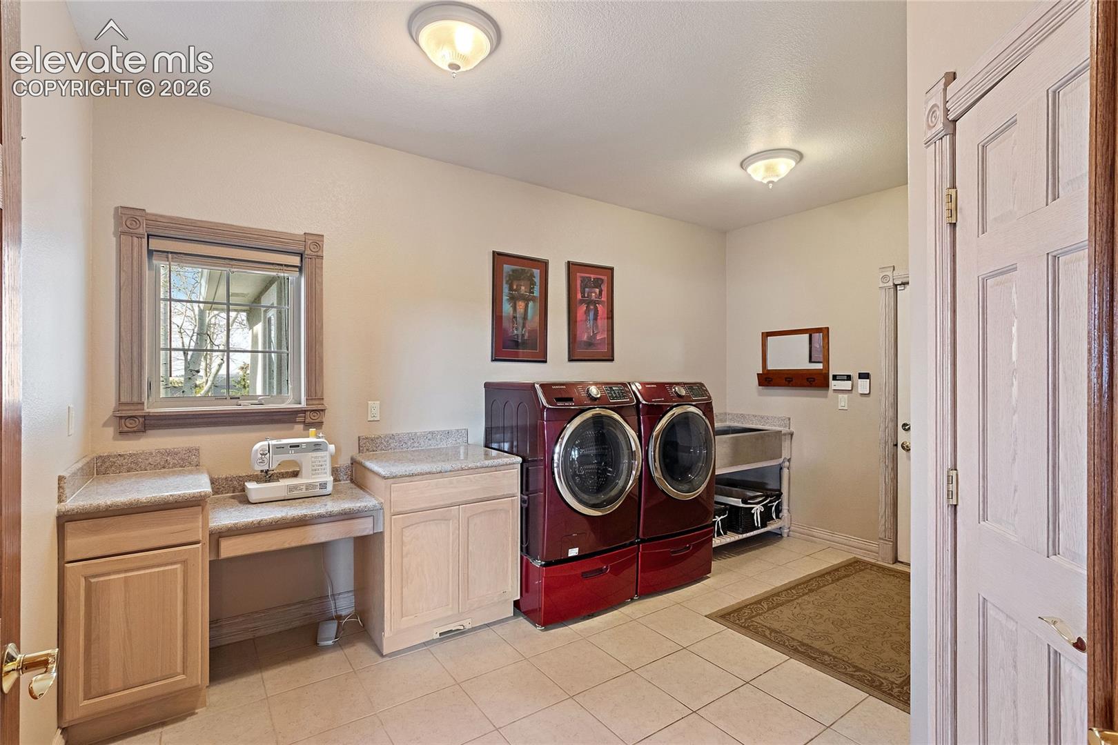 Main floor laundry room with half bath and large storage closet to the right