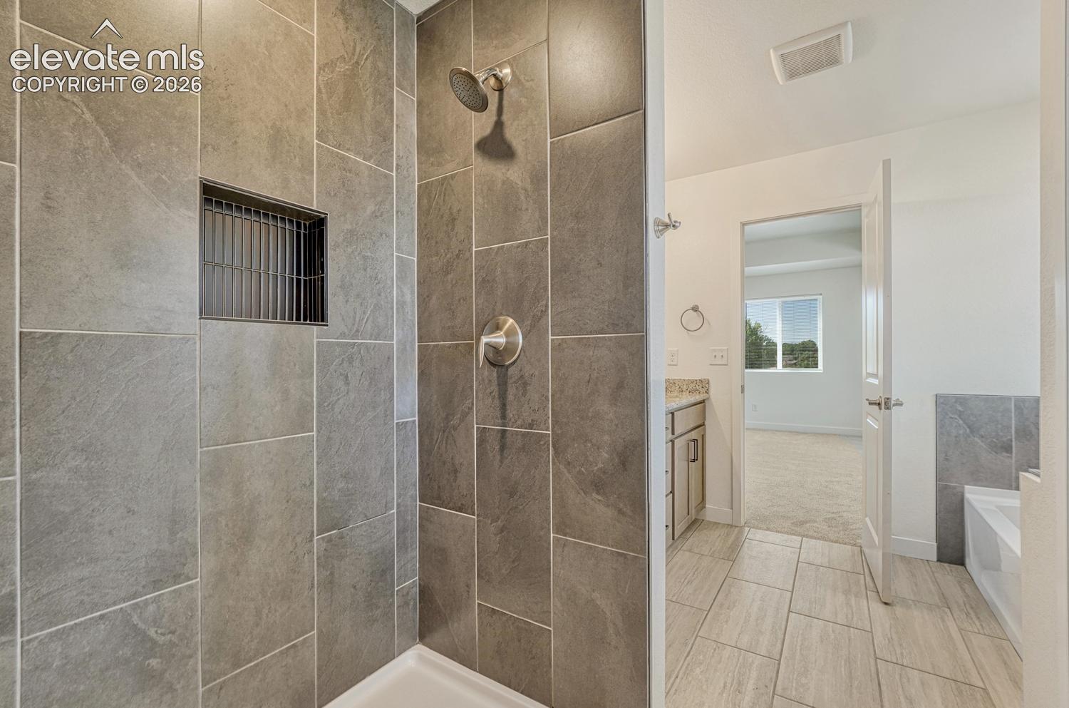 Walk-in shower with floor-to-ceiling tile surround