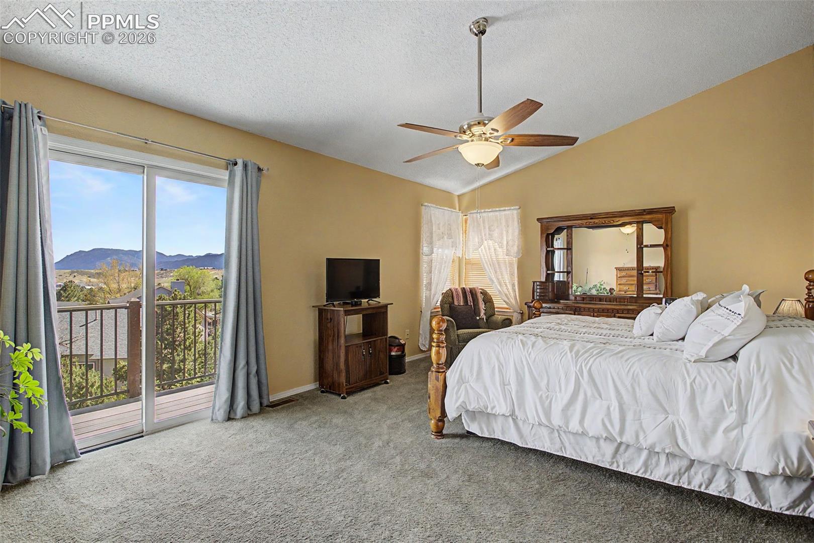 Upper level Primary bedroom, sliding glass door leads to private upper deck.