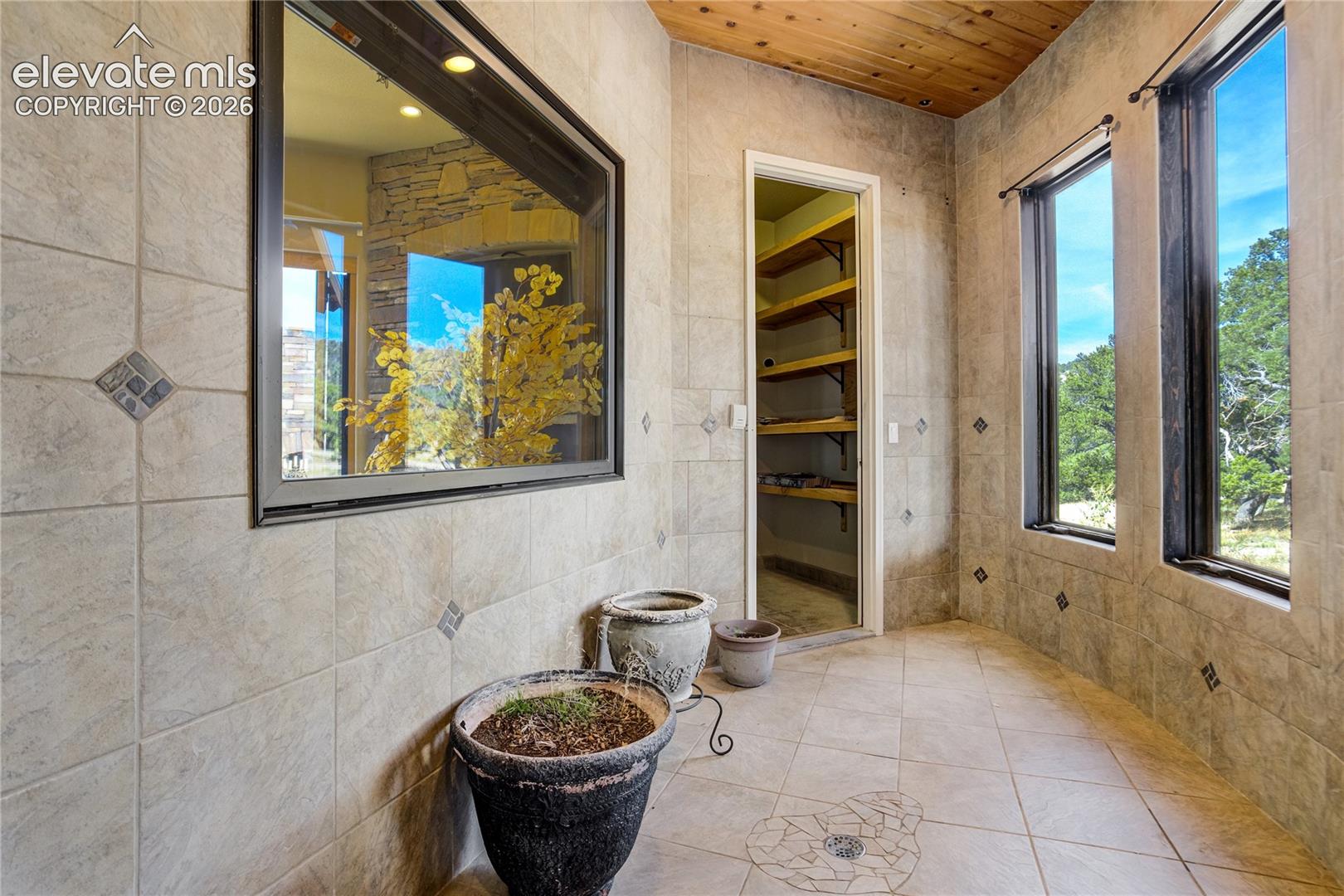 This is a custom garden room with drain/water hookups and adjacent storage - walks out to courtyard