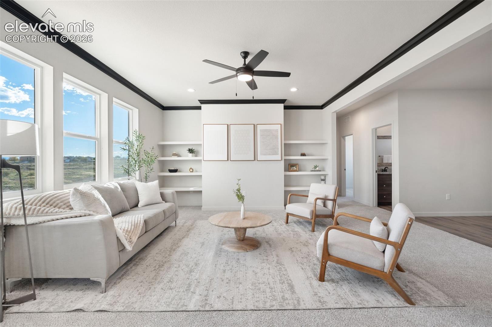 Recessed lighting, ceiling fan, built-in shelving, crown molding, and large windows