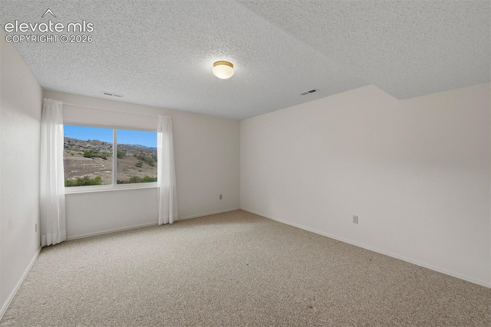 Basement 3rd bedroom all above grade; no window wells. 
