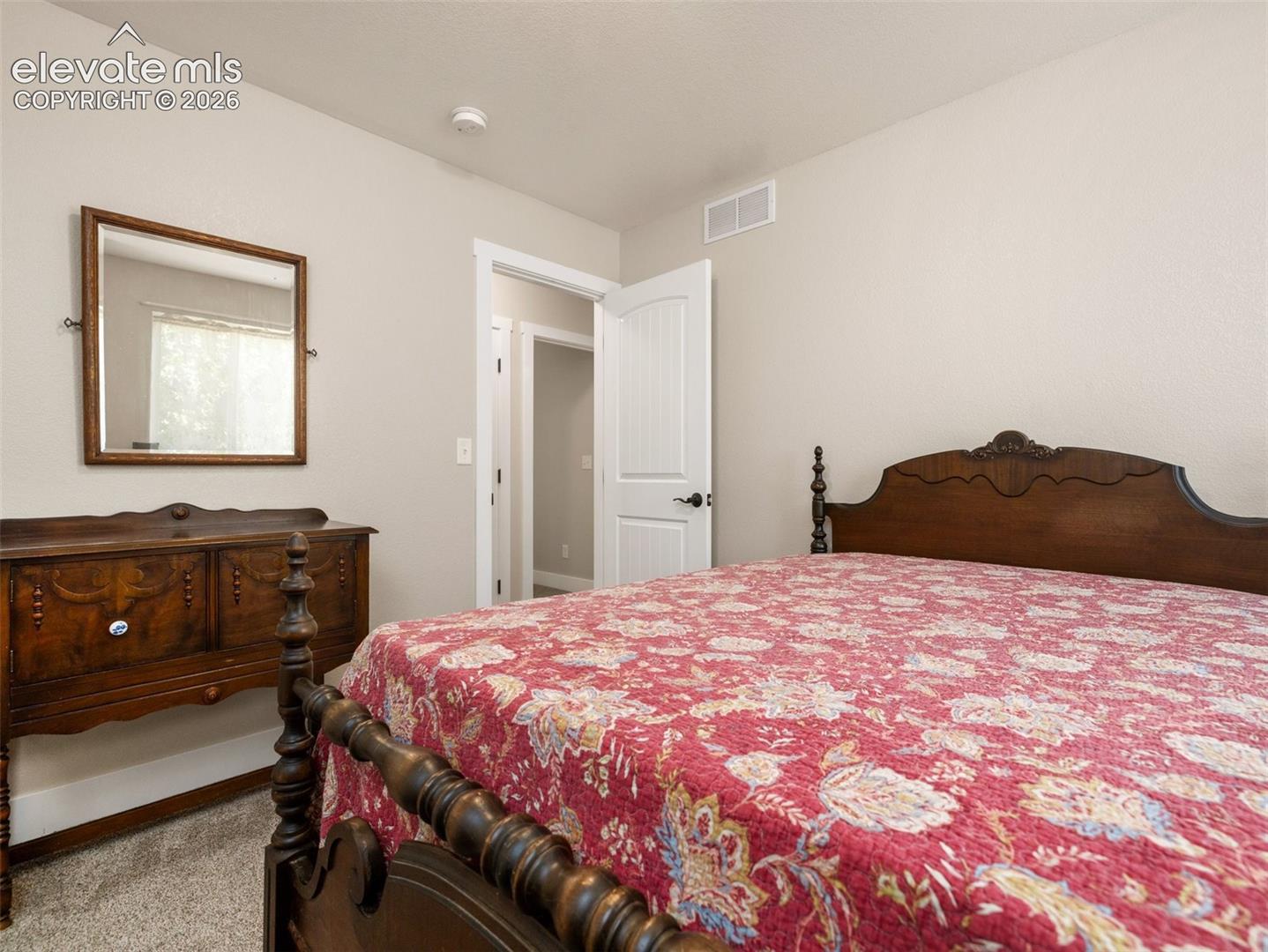 Neutral wall color, carpet flooring, and white trim