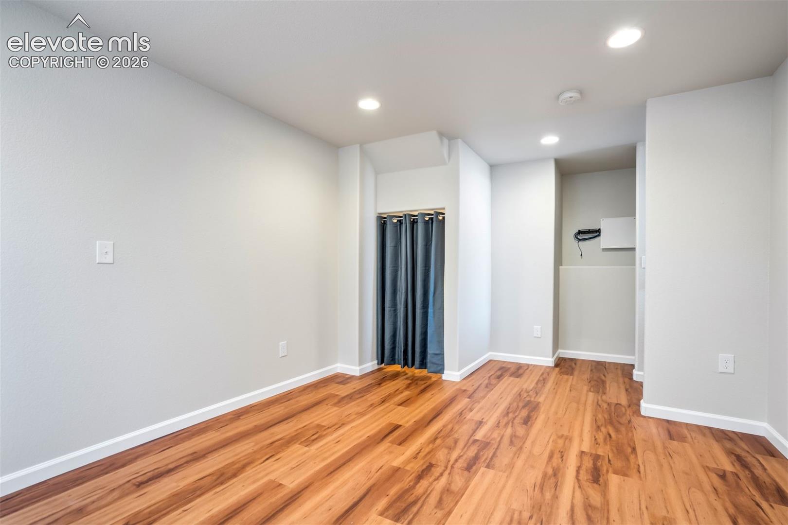 Engineered flooring and recessed lighting in the basement. 