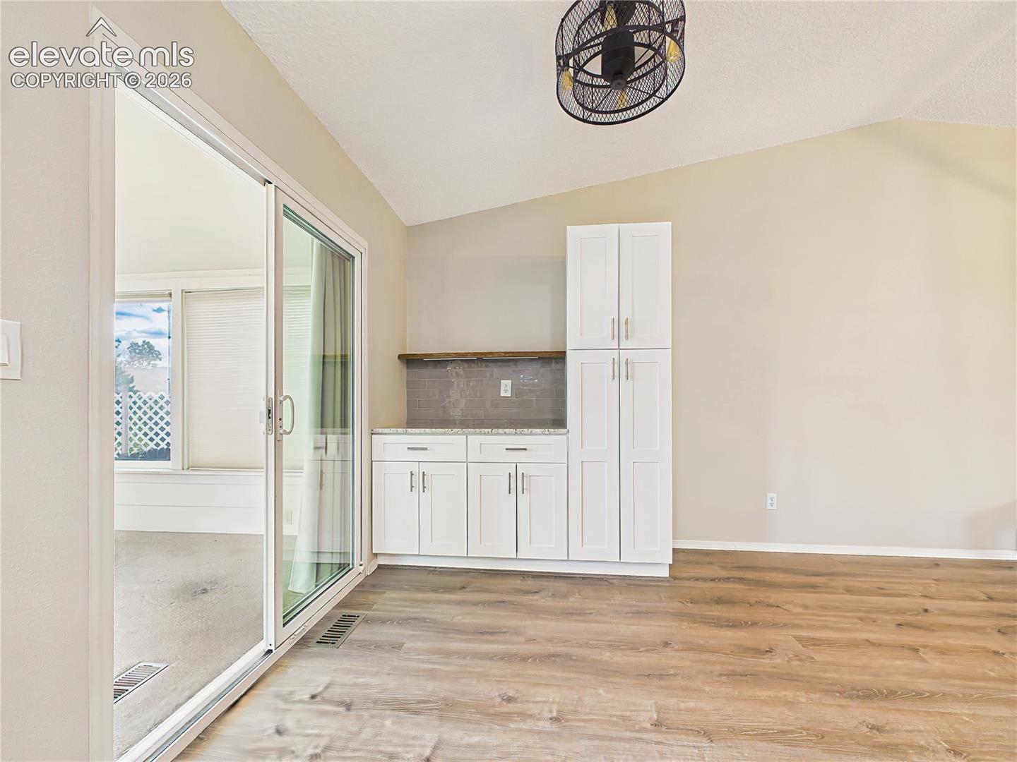 Kitchen & Coffee Bar – Flexible kitchen space with extra cabinetry, built-in serving area, and convenient access to the adjoining sunroom.