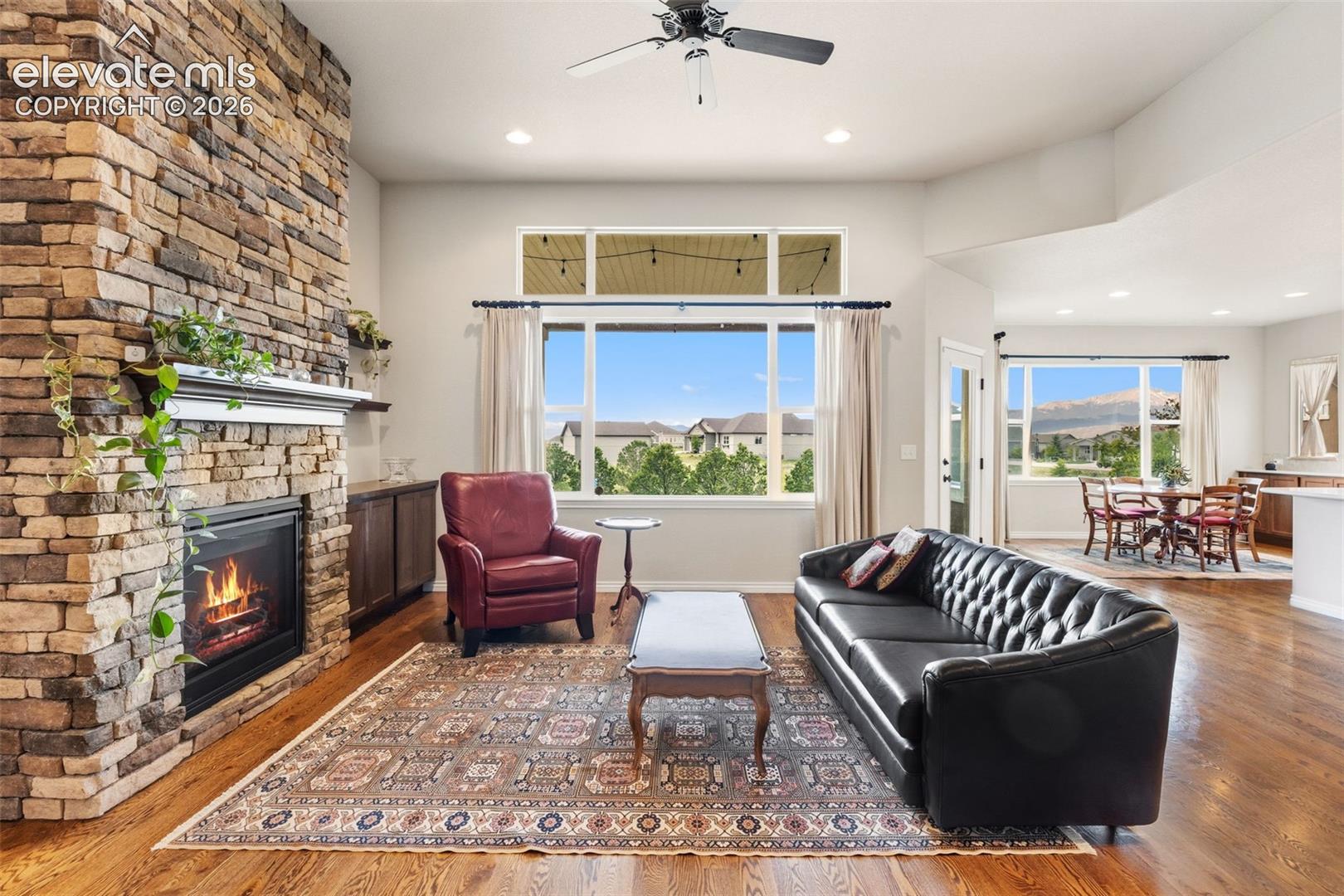 Living room with view across back of property and stunning brick fireplace